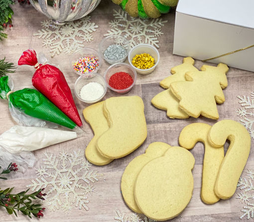 Christmas Cookie Decorating Kit By Sweet-Traders with red, green, and white frosting and assorted sprinkles.